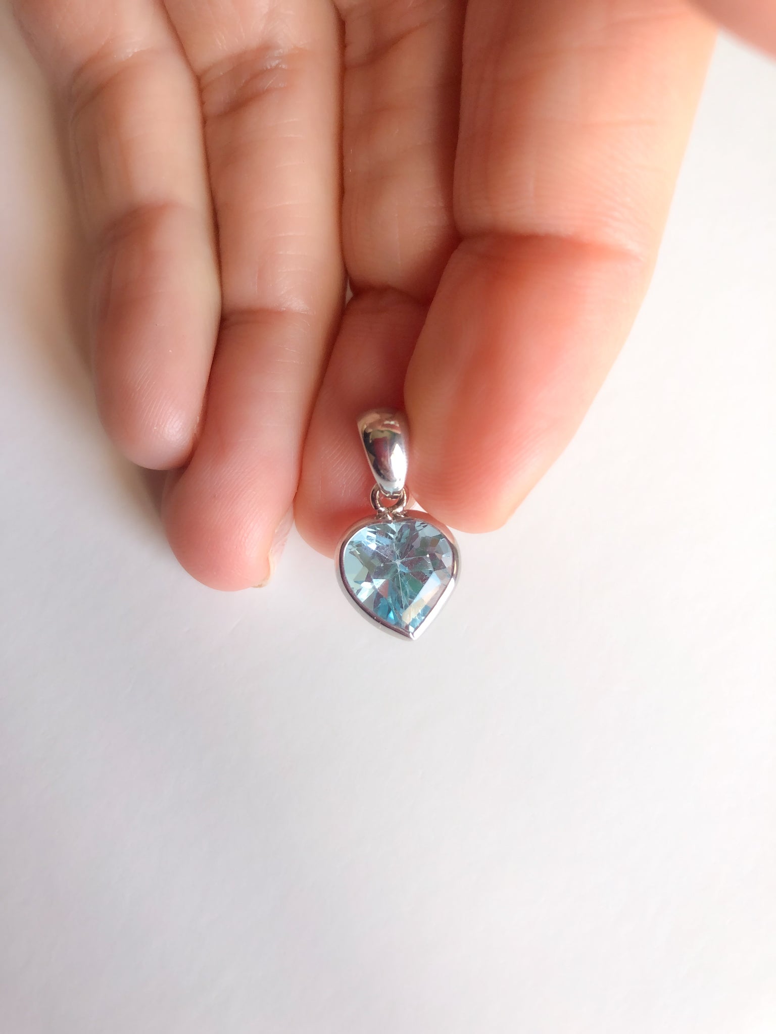 White gold blue topaz heart pendant